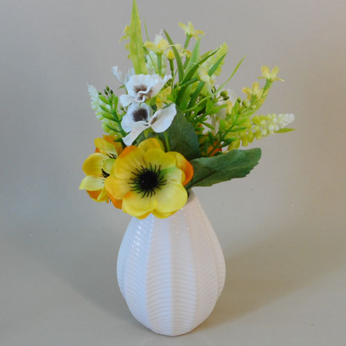 yellow artificial flowers in vase